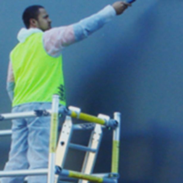 Worker painting a wall for renovation